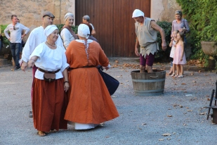 Medieval dance display with grape stomper