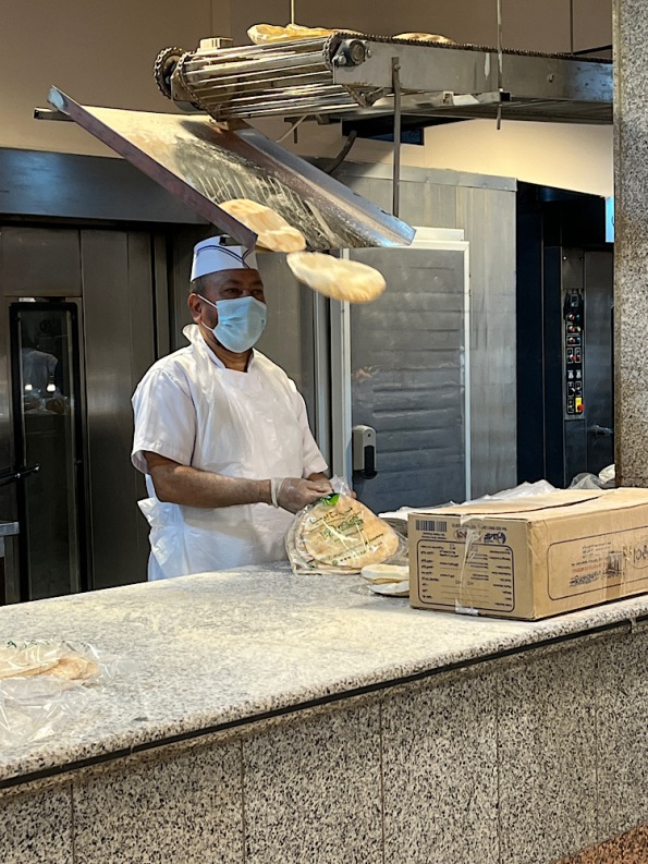 Two loaves of bread fall from conveyor belt